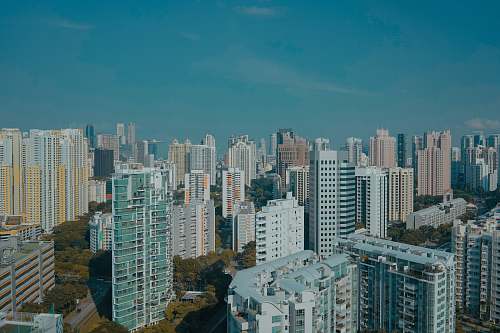 high rise aerial photography of building under clear blue sky urban